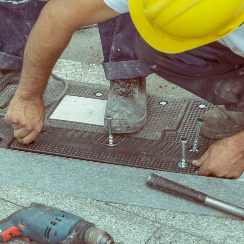 workers-hand-screws-a-screw-in-a-rubber-board-with-2026-01-11-09-27-23-utc